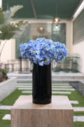 8 blue artificial Ortancia flowers in black Aris vase Egypt