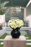artificial white plumeria flowers Egypt in minimalist circular black vase