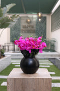 purple artificial orchid in black vase Egypt