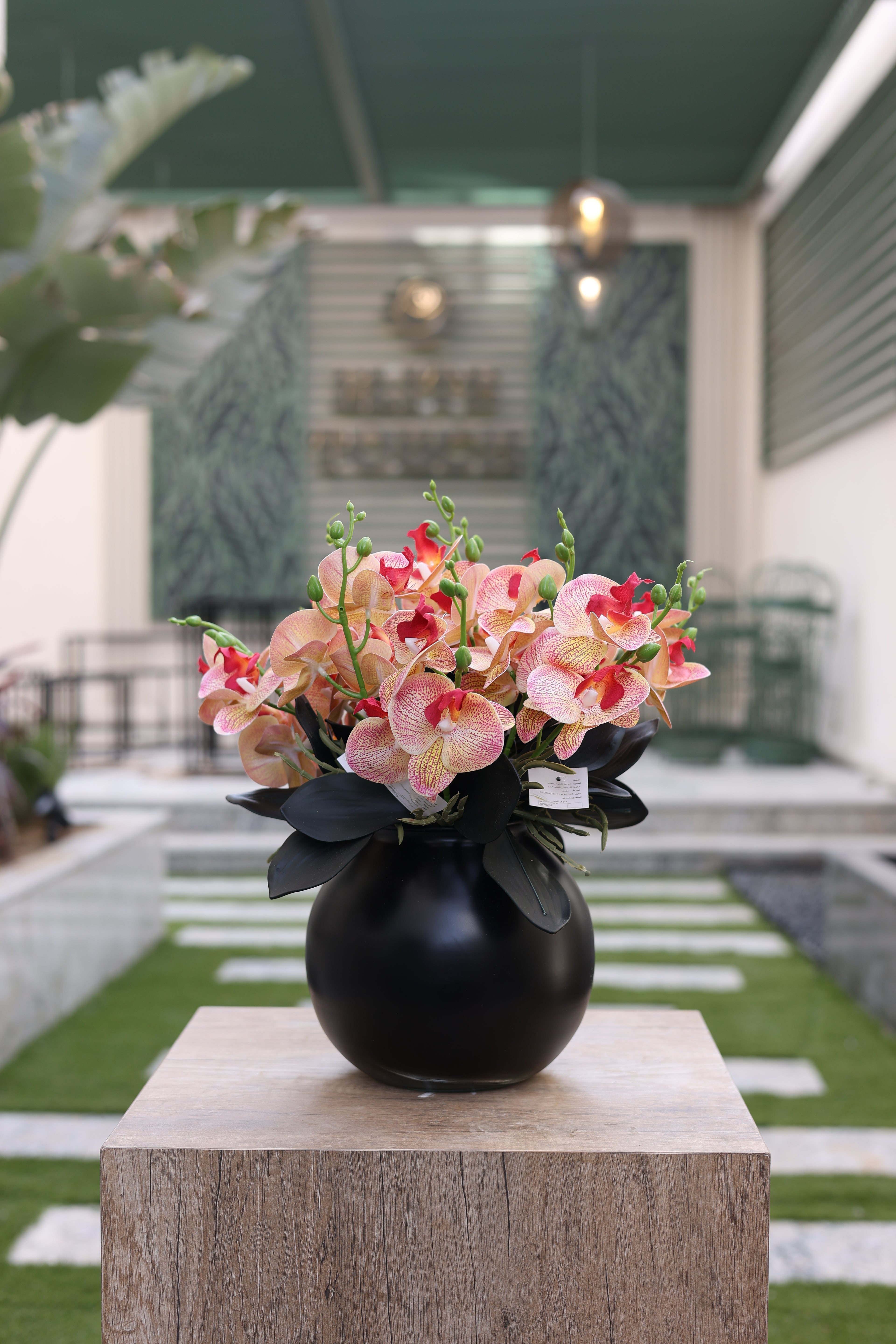 multi-color artificial orchid flowers in circular black vase Egypt