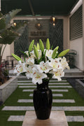 white artificial lilies 9 stem in glass vase Egypt