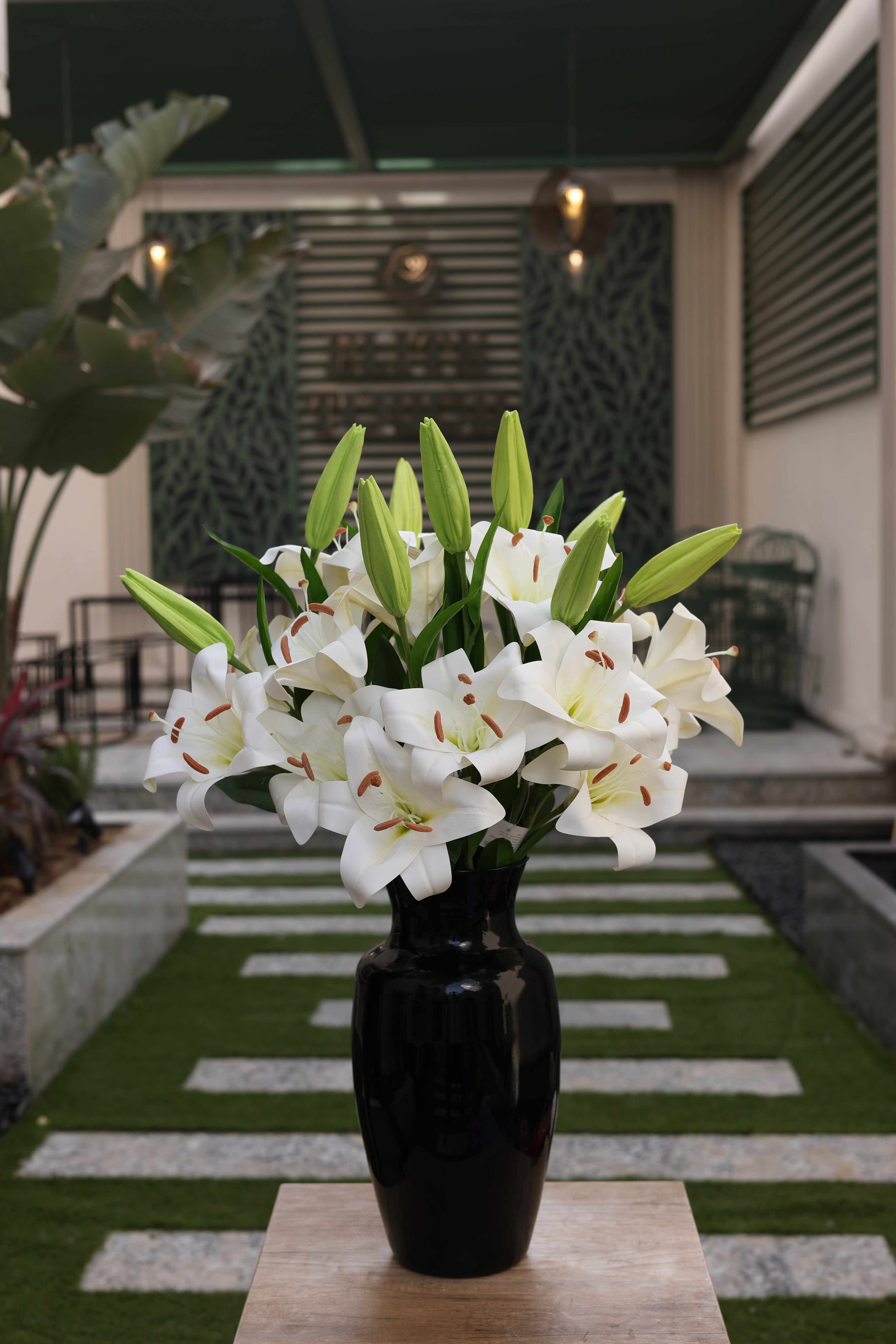 white artificial lilies 9 stem in glass vase Egypt