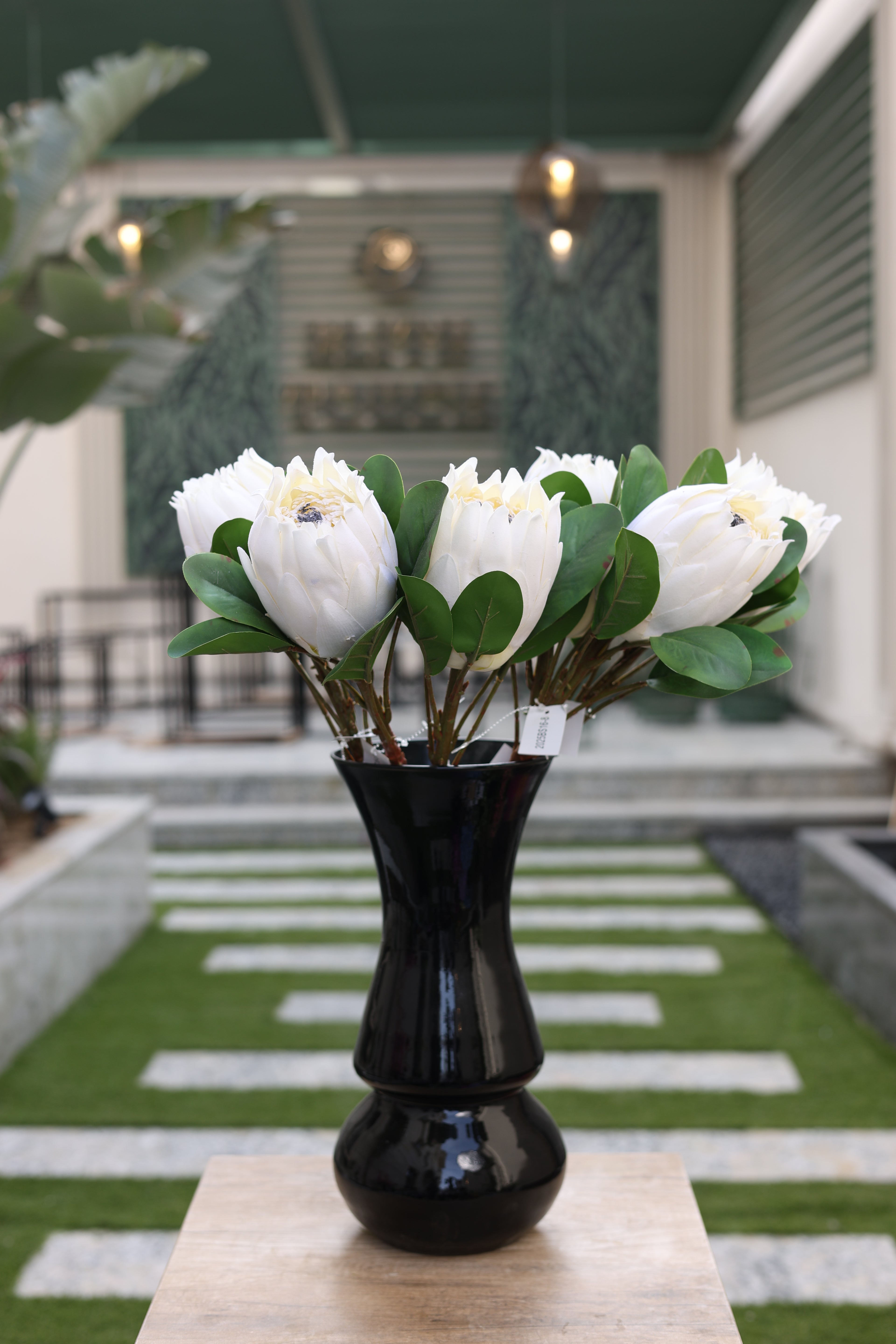 white artificial Poritia 6 stem in glass vase Egypt