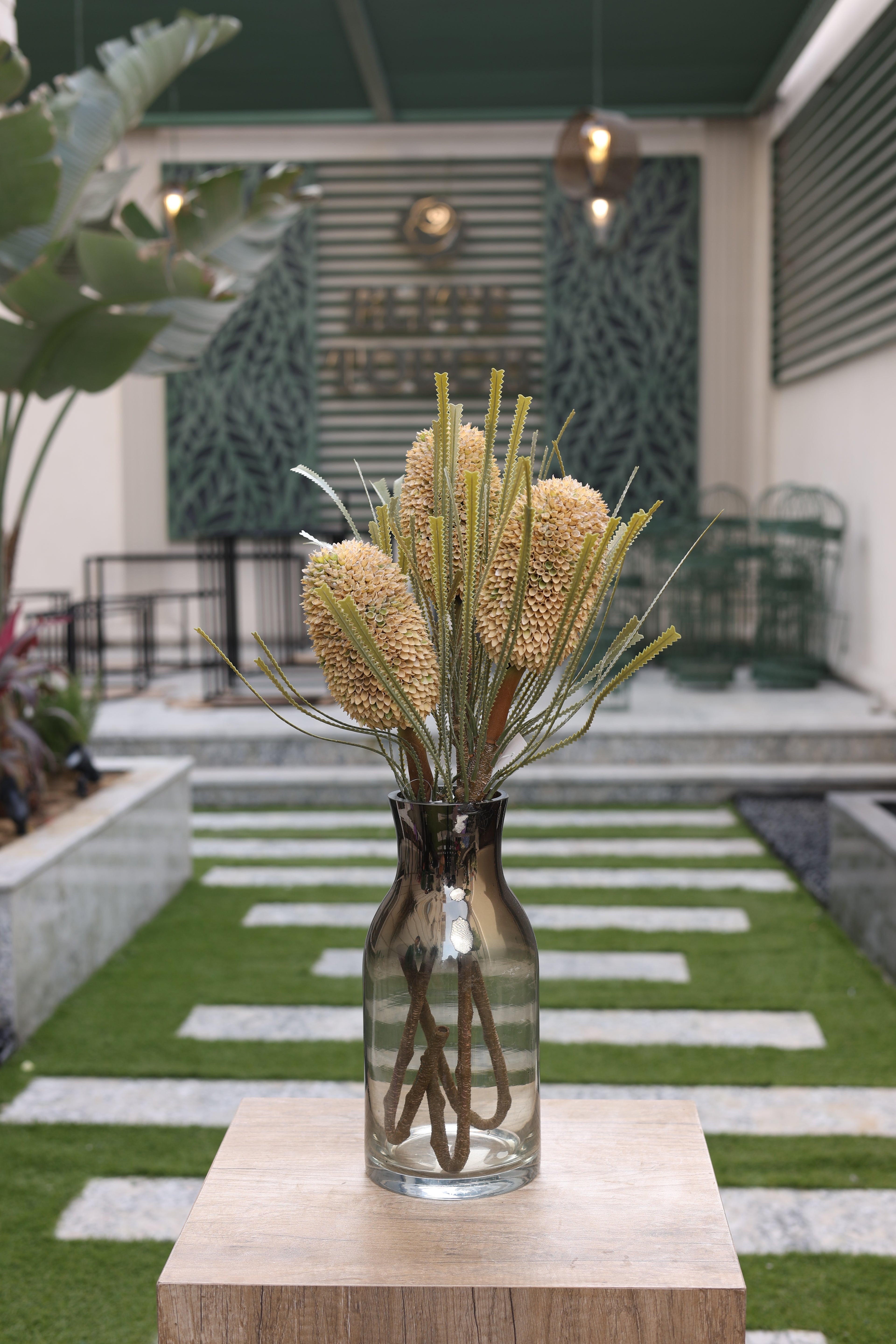 cream artificial Banksia 3 stem in glass vase Egypt