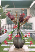 artificial pineapple and baby orchid in glass vase Egypt