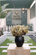 yellow artificial ment flowers in glass vase Egypt
