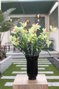 artificial orchid and green foliage in glass vase Egypt