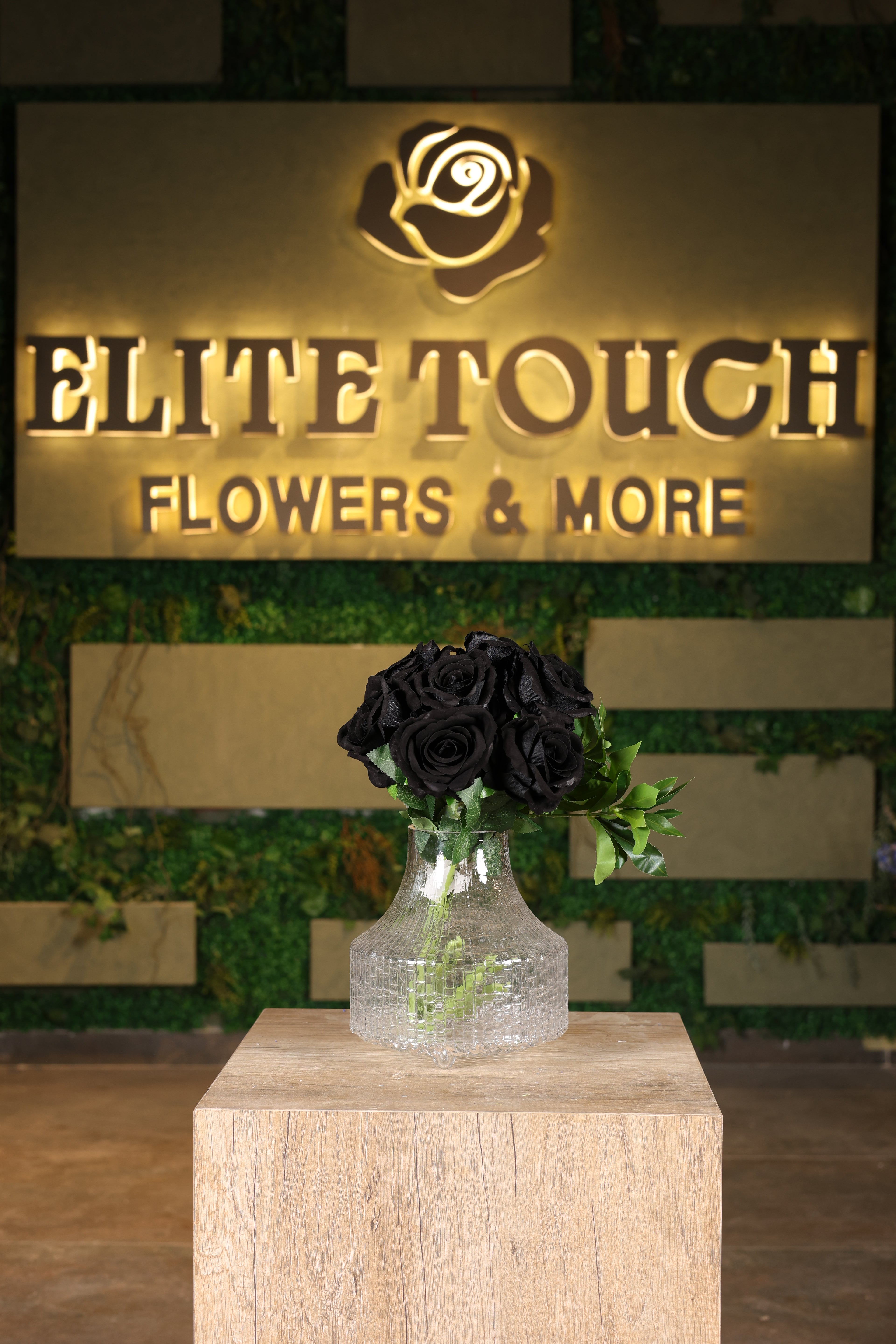 artificial black flower and green foliage in glass vase Egyp