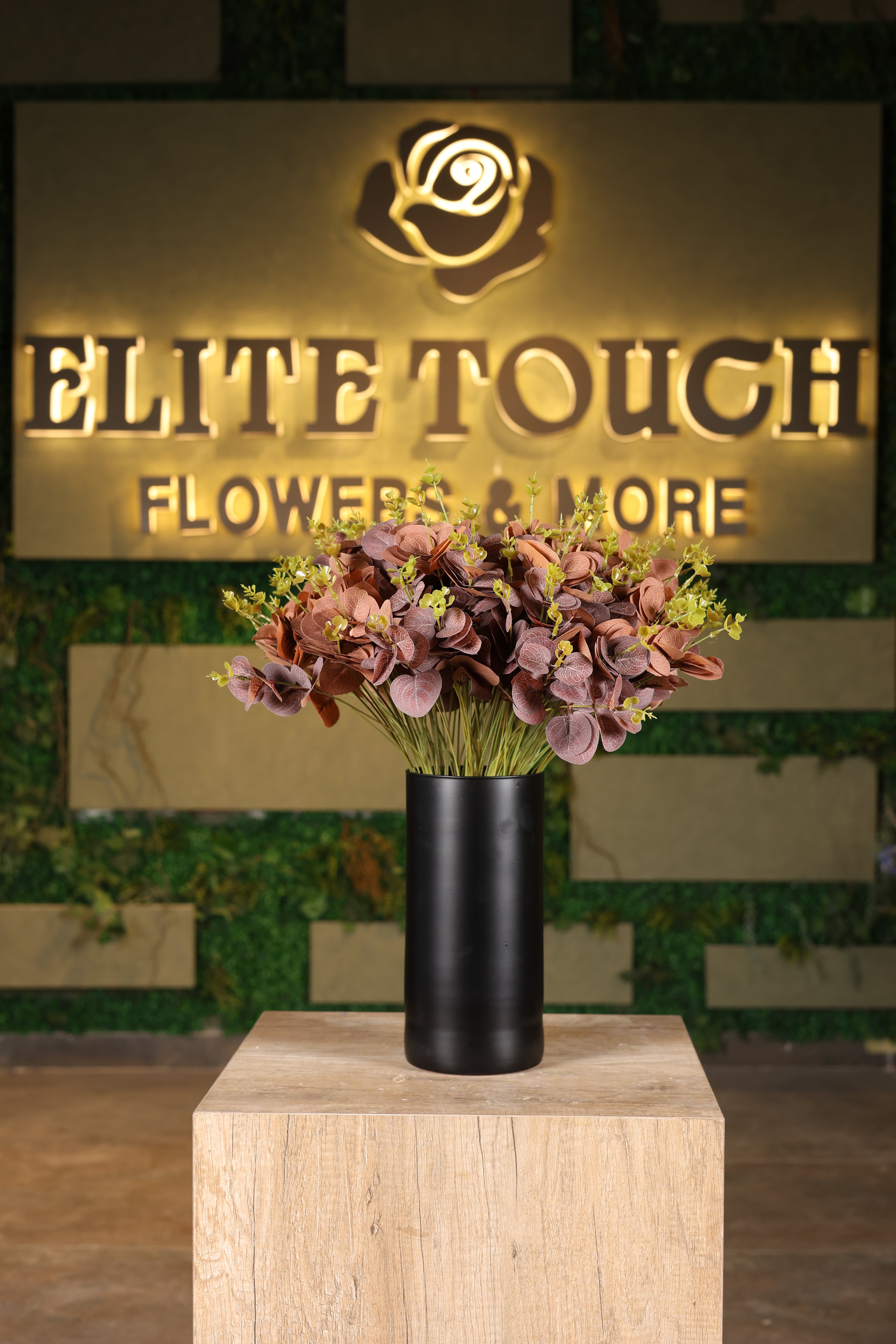 tall artificial green foliage in glass vase Egypt
