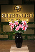 medium artificial lilies in glass vase Egypt
