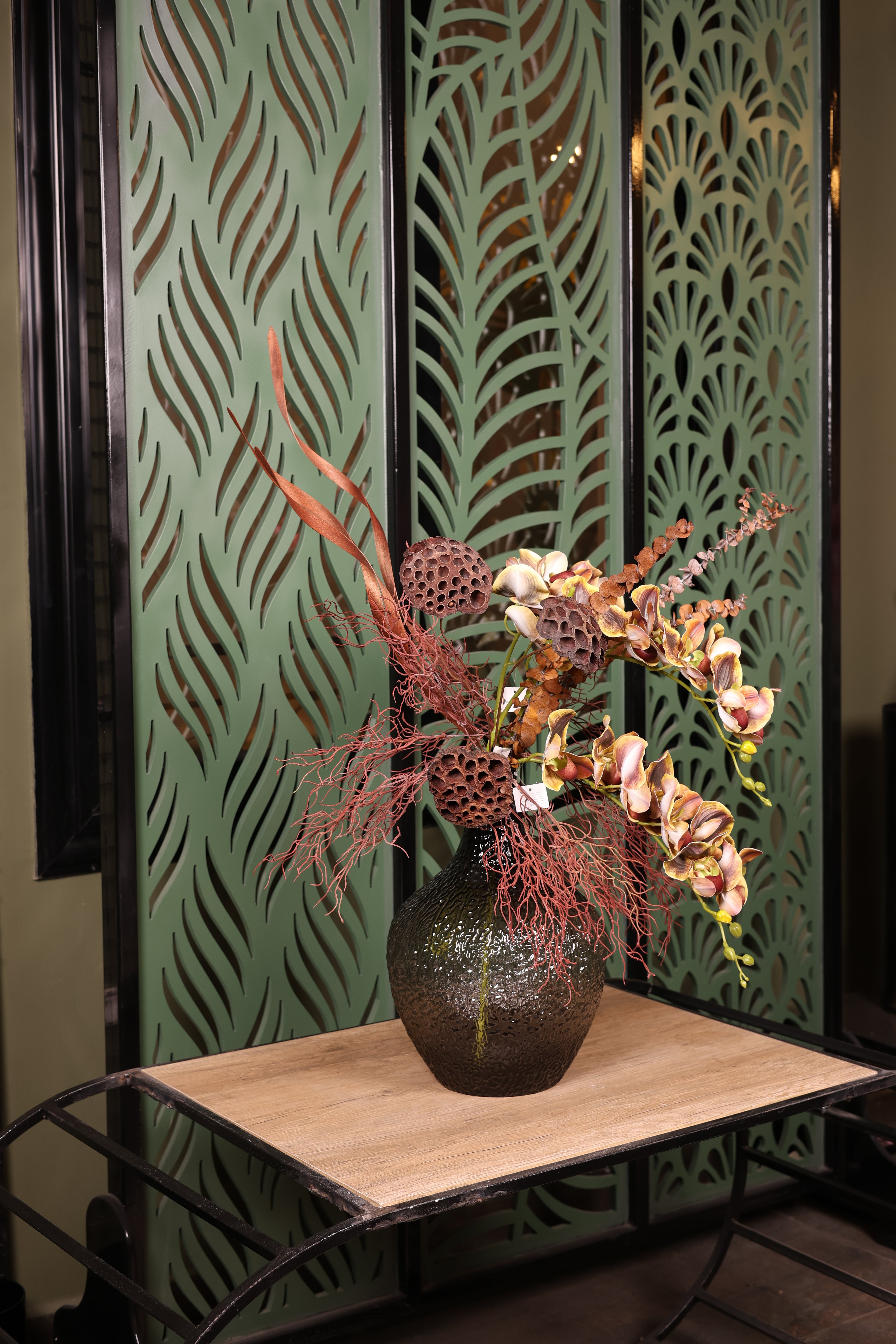 artificial orchid green foliage dried flower in glass vase Egypt
