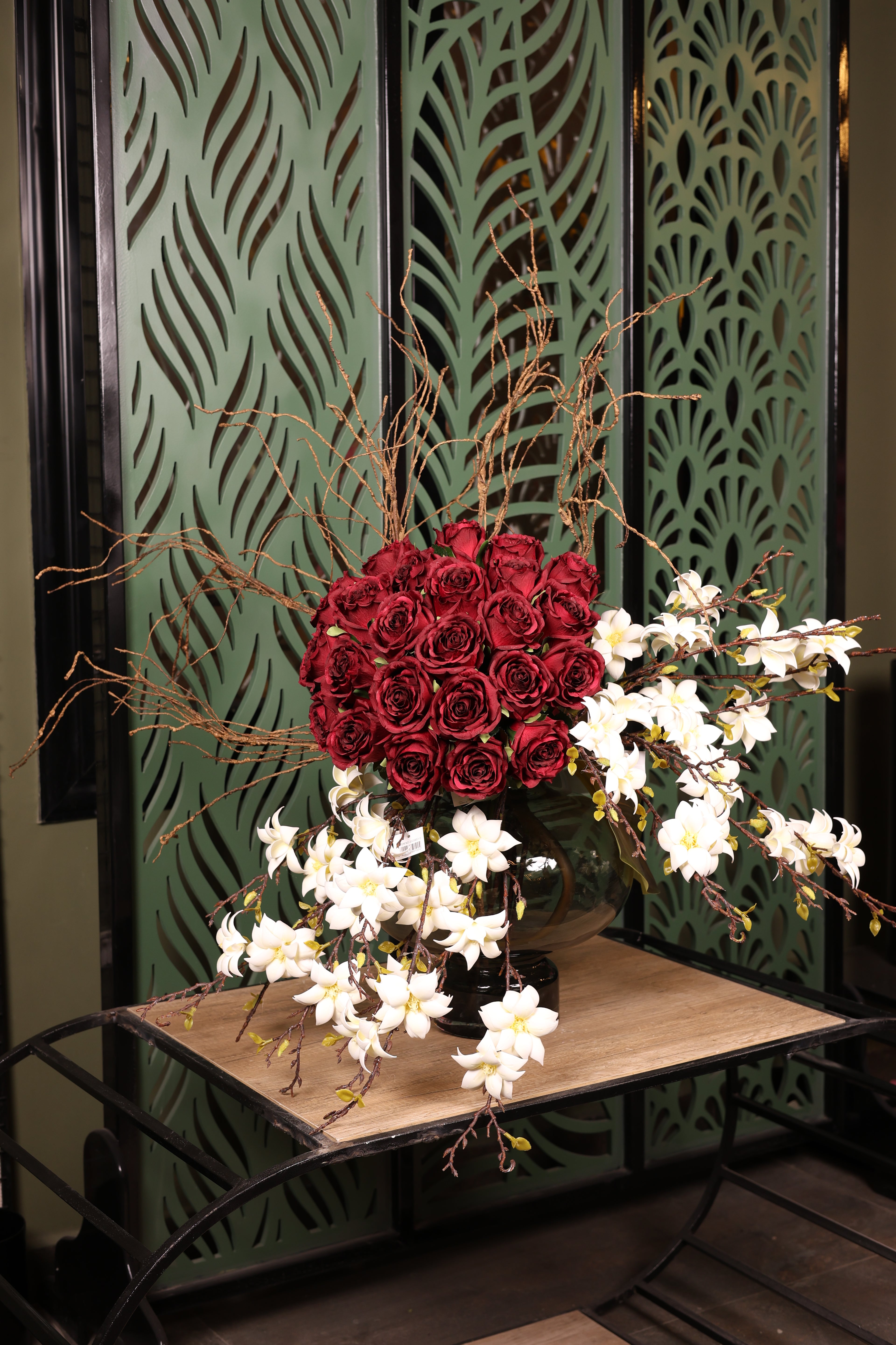 artificial magnolia and red flower in glass vase Egypt
