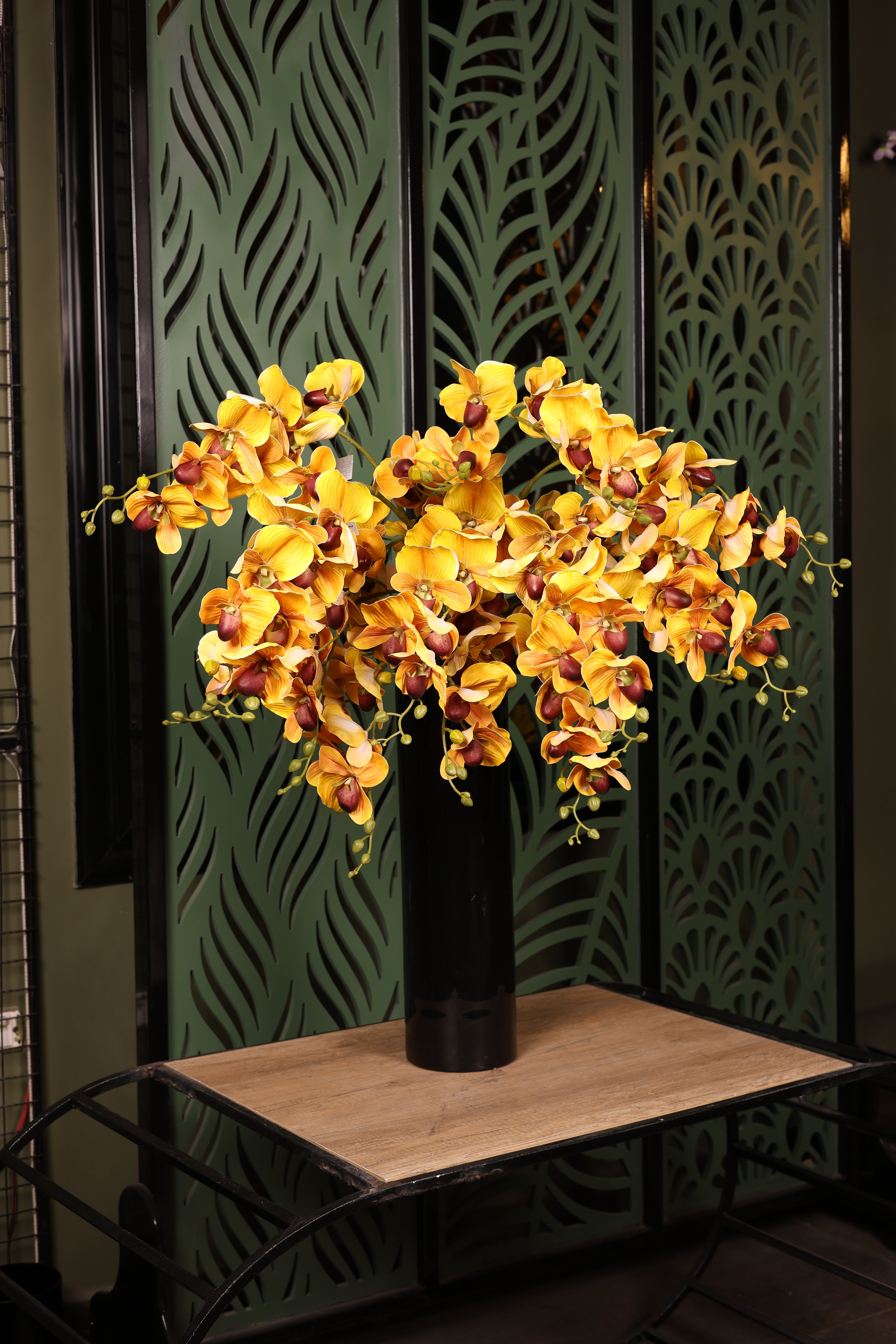 premium artificial orchid and green foliage in glass vase Egypt