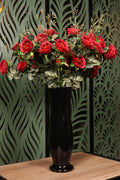 artificial mixed flowers and green foliage in glass vase Egypt