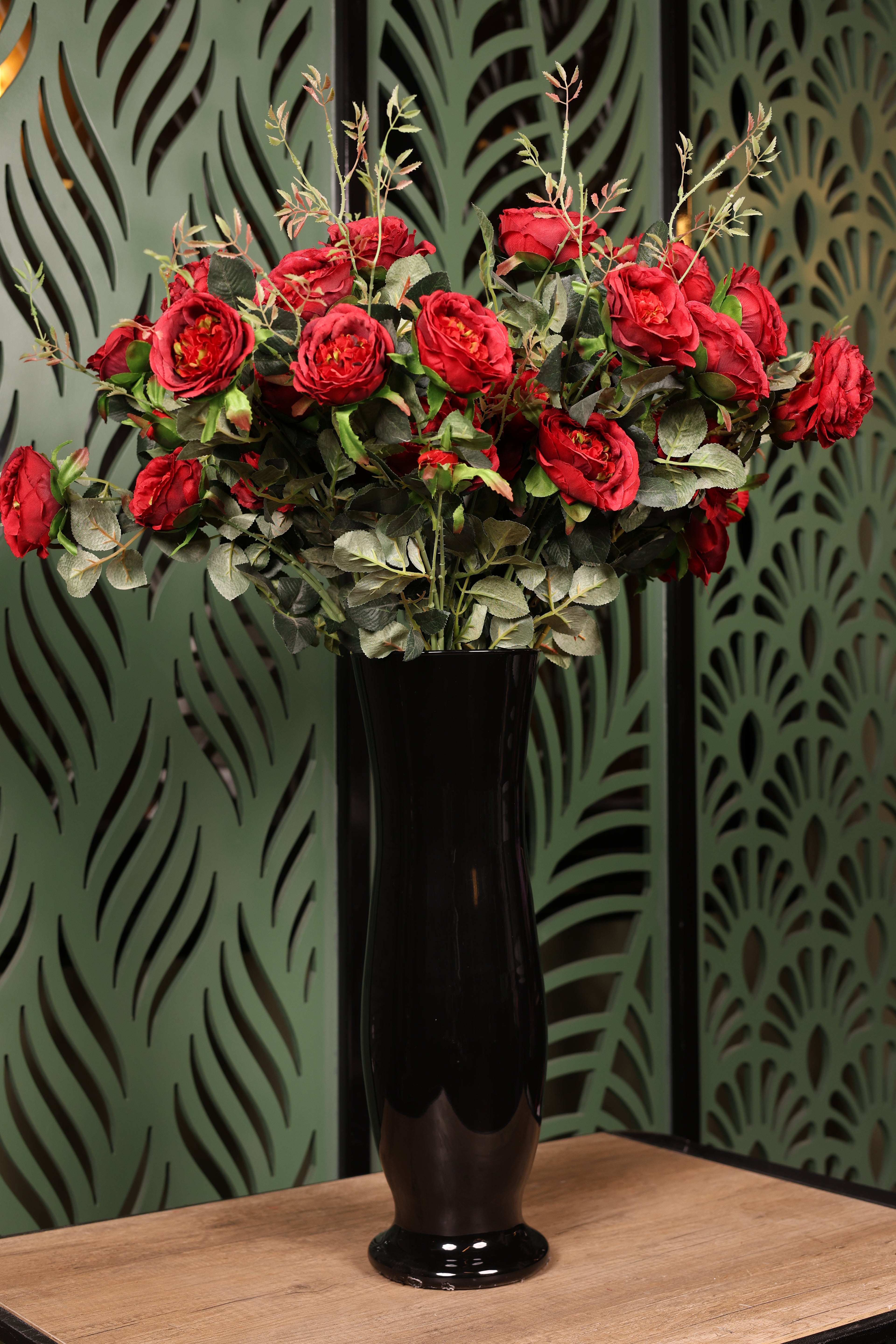 artificial mixed flowers and green foliage in glass vase Egypt